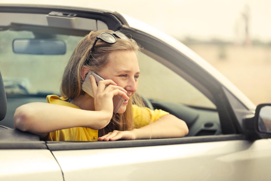 A person speaking hands-free into their phone while walking outdoors