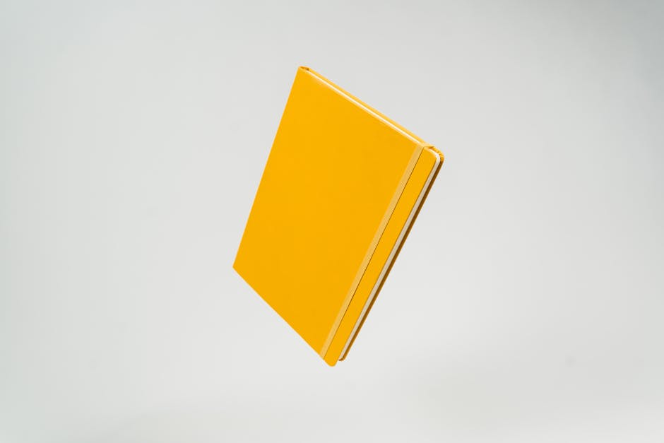 A single minimalist notebook lying on a clean, empty desk