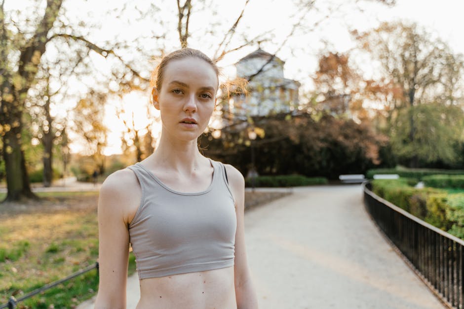 A clean white desk with an open weekly planner and a single pen, viewed from above in natural light