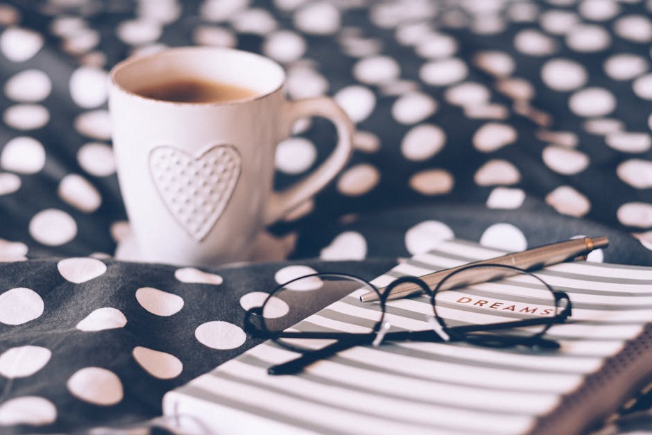 A person planning their day with a cup of coffee and notebook