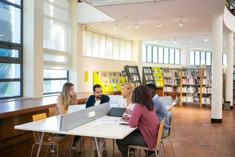 Students working together on a group project around a campus table