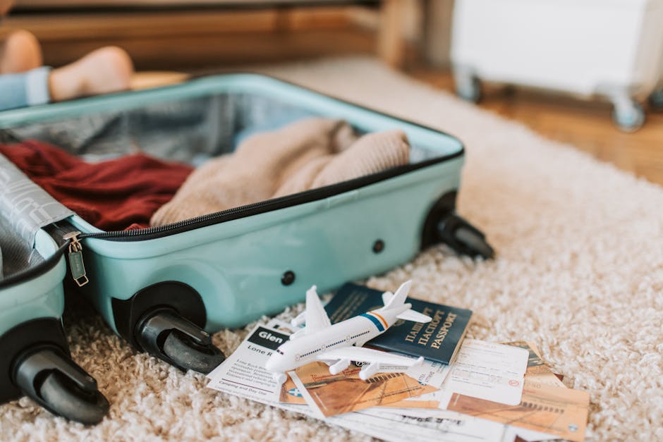 A suitcase and travel items laid out for packing
